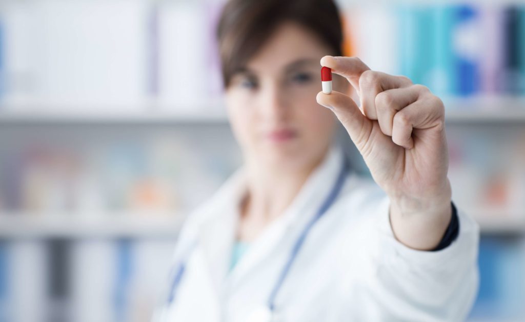 Pharmacist holding a pill