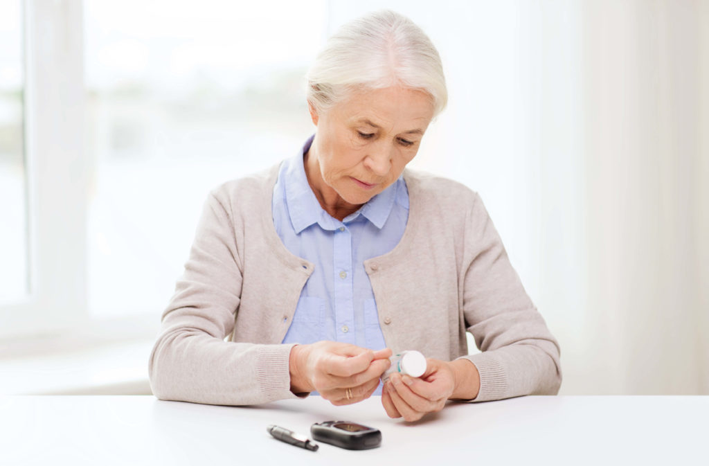 Elderly woman reviewing medication bottle
